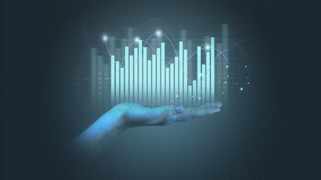 Hand holding a holographic graph and data visualization